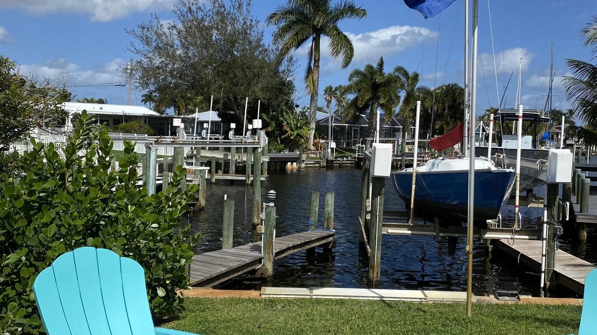 Palm City Cottage | Tropical Getaway! Waterfront Bungalow with Heated Pool, Firepit, & Kayaks