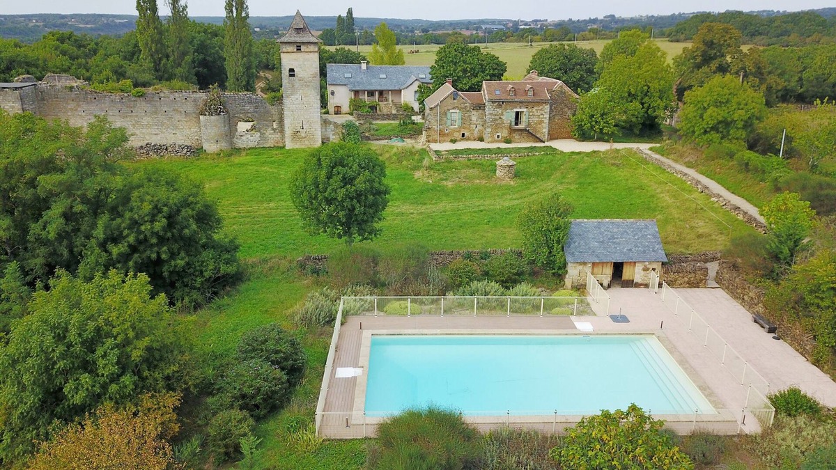 Ginals House | Two houses with a large swimming pool next to the ruins of a medieval castle
