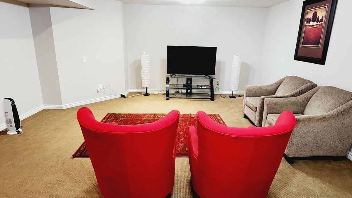 Airdrie House | Unique full basement suite with spacious living room.