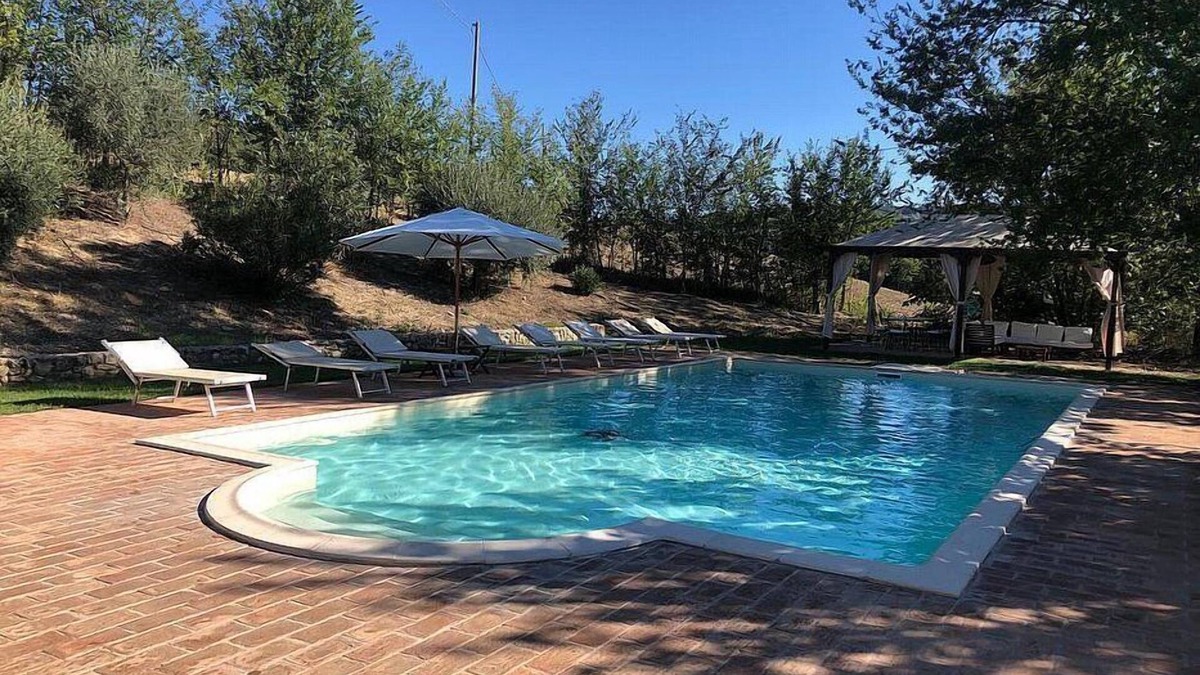 Todi Villa | Villa Gramigna: A charming two-story villa surrounded by the greenery.