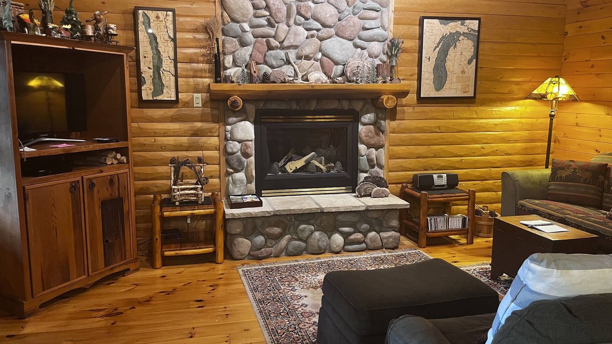 Bellaire Cabin | Waterfront log home on Lake Bellaire. Pet friendly. Fireplace, dock. dog ok