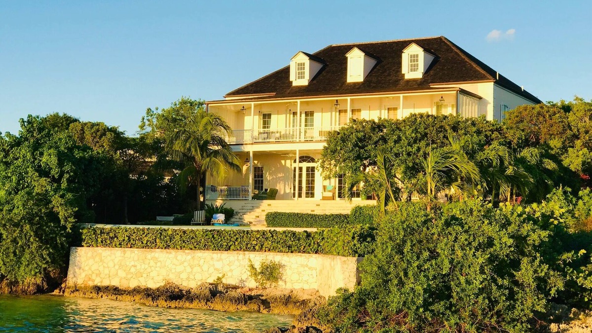 Dunmore Town Villa | Wind Whistle Harbour Villa- a classic Bahamian 2.5 story veranda-style house.