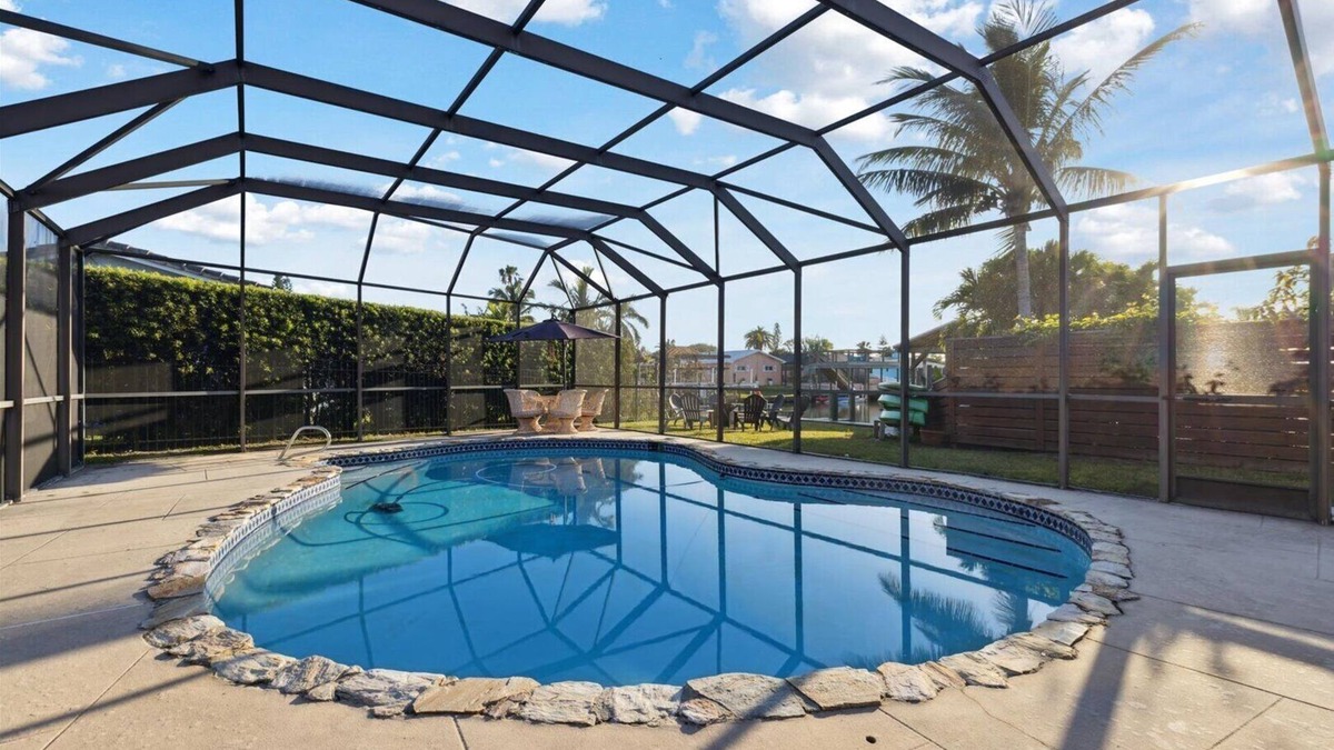Venetian Way House | Your Ultimate Coastal Retreat! Stunning 4-Bed Canal-Front Home w/Pool & Lanai