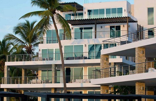El Batey Apartment | 2BD beachfront condo in gated luxury residence, gym/pool, near everything