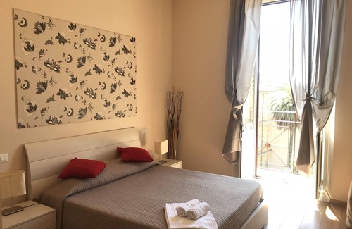 Esquilino Bed & Breakfast | Aria Rome Rooms triple room with balcony view of Basilica di San Giovanni