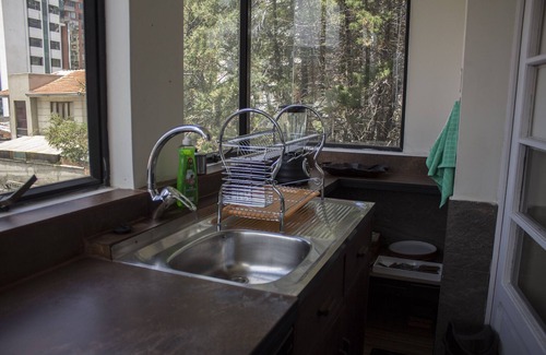 Downtown La Paz Apartment | Bedroom + living room. Central heating, fireplace and garden