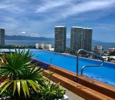 North Hotel Zone Apartment | Chic 1BR 1BA Zoho Skies condo with rooftop pool stunning views