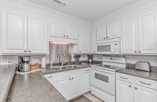 Surfside Beach Condo | Enjoy the warm breeze from your balcony. Baste in the sun. Walk to dinner!n