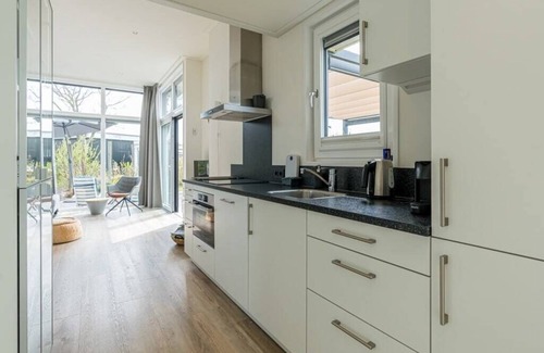 Burgh-Haamstede House | Extensive garden with spacious terraces and even space for a relaxing hammock. With the shade cloth