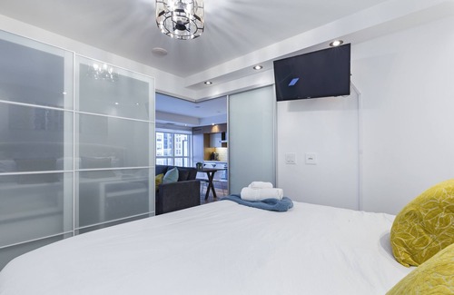 Toronto Entertainment District Condo | King Bed CN Tower Suite w/Office, Den, Bidet, Balcony & Free Parking