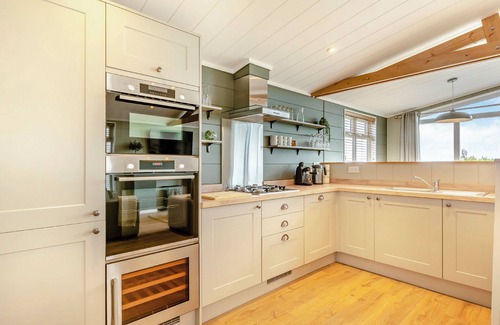 Middlezoy Ski Chalet | Luxurious lodge with vaulted ceilings and a welcoming feature fireplace.