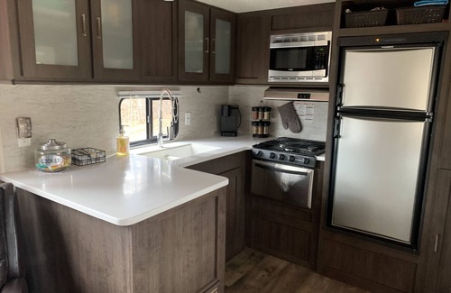 Clare House | Modern RV camper with all the perks nNestled in tree at lake edge
