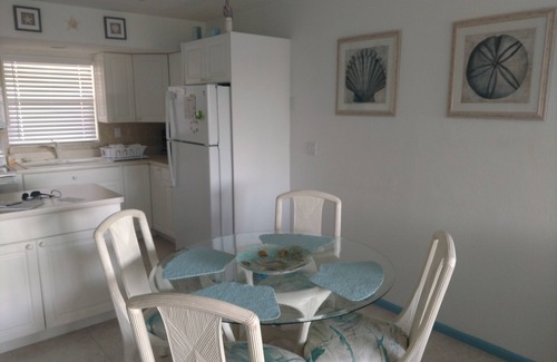 Marco Island Condo | Modern top floor with a beautiful view of the bay, pool, waterfront restaurant