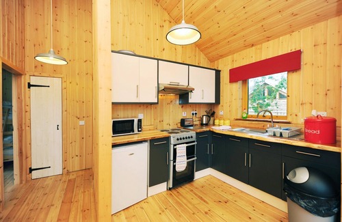 Taynuilt Cabin | OAK is a charming, well equipped log cabin with hot tub and wood burning stove