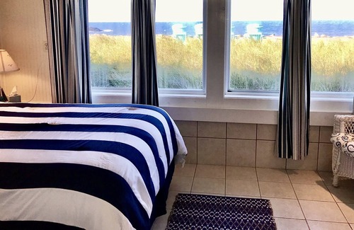 Adamsville Cottage | Oceanfront Cottage with Private Beach and Courtyard. Outside Bar & Fire Table.