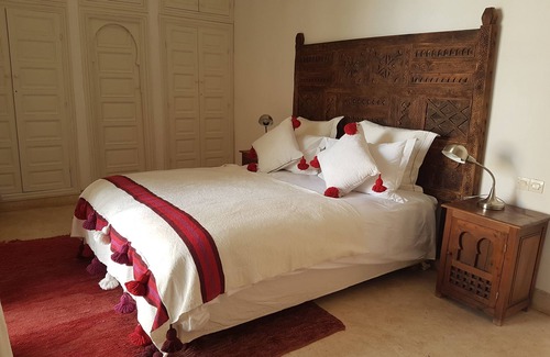 Oumnass House | Pool-view romantic bedroom