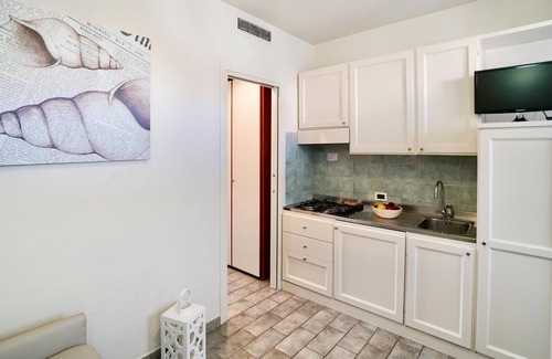 Vada Apartment | Relax in this cozy vacation home with a shared pool.