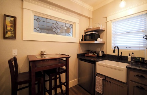 Historic Downtown District Apartment | Relax in the luxurious 1-bedroom Louisa Suite at RedTail Inn. Enjoy a double rain shower, plush linens, and a shared hot tub. Located near downtown Ashland, with off-street parking and high-speed WiFi.
