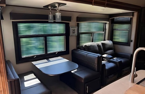 Kenora Resort | RV 5 Rustic Charm w/Queen Bed with Forest Background