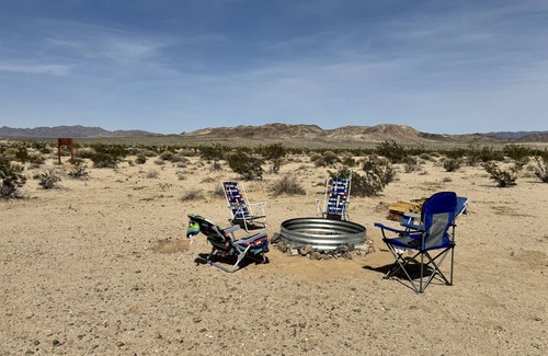 Wonder Valley RV Rental | RV space with fire pit under the stars