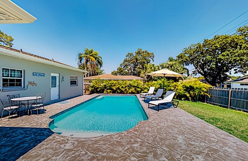 Harbor Bluffs House | Single-story home with outdoor dining, firepit, home office & laundry room
