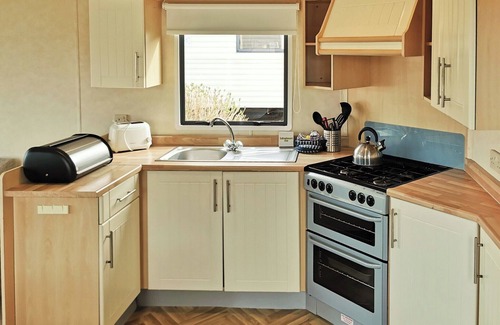 Llanllwchaiarn House | Spacious and comfortable 12ft-wide caravan with one double and two twin.