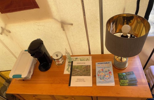 Middle Grove RV Rental | Unplug in comfort—glamping tent with real beds, electricity, fire ring, bathhouse, and nearby pond.