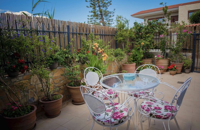 250 metres from the sea a tiny independent house with a yard full of flowers!