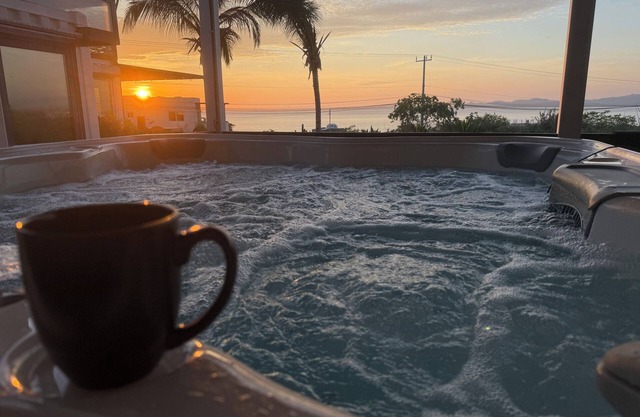 3 bedroom, 3 bath premium stylish shipping container home. Game room w/darts, shuffleboard, video game cabinet, Infinity game table, new 8 person hot tub, multiple decks w/firepits, fast Wifi (250 mb+)w/Starlink backup. Free use of two SUPs.