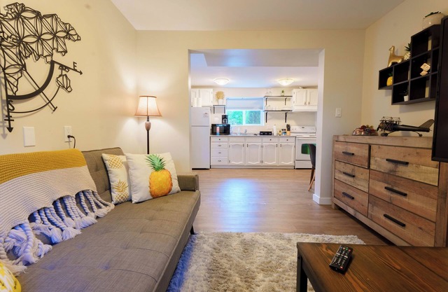 A bright and cozy 1-bedroom basement suite is nestled in a lush garden setting