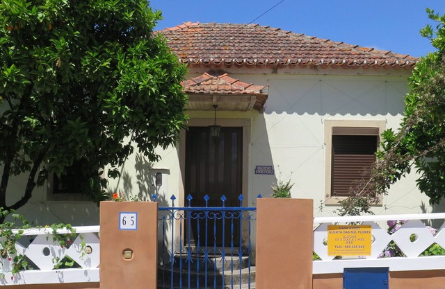 A charming cottage surrounded by gardens in a small hillside hamlet