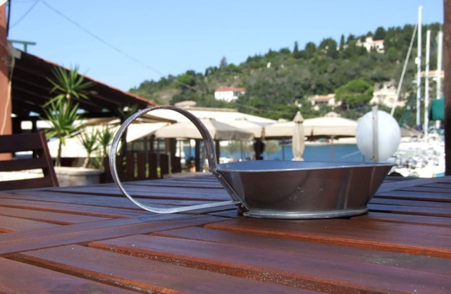 A Lovely beachfront stone house with a large yard and garden in Lakka Paxos.