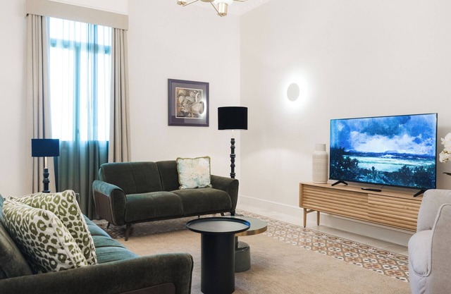 An elegant retreat in the heart of Balluta Bay, this designer apartment blends refined textures, plush emerald seating, and timeless floor patterns to create a luxurious sanctuary steps from the sea.