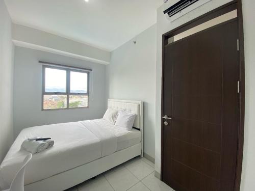 Bright and Relaxing 2BR Apartment at Mekarwangi Square Cibaduyut By Travelio