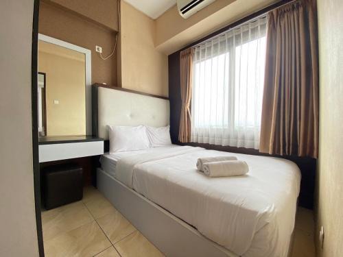Comfy & Well Appointed 2BR at Tamansari Panoramic Apartment By Travelio