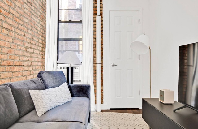 Deluxe LES 1BR w/W/D, steps to B/D Train & Park, by Blueground