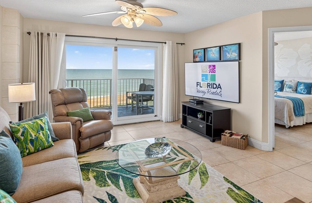 Direct oceanfront condo with a private balcony, heated beachfront pool, and garage