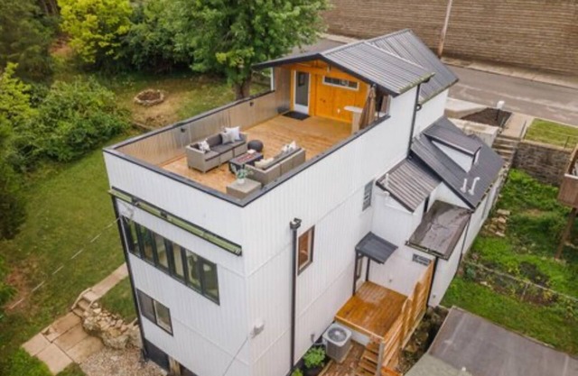 Downtown skyline view featuring giant rooftop deck & wet bar with a city view.