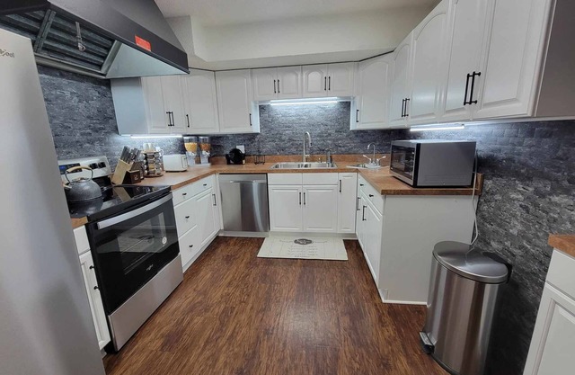 Five bedroom house with hot tub and full fenced cozy private backyard.