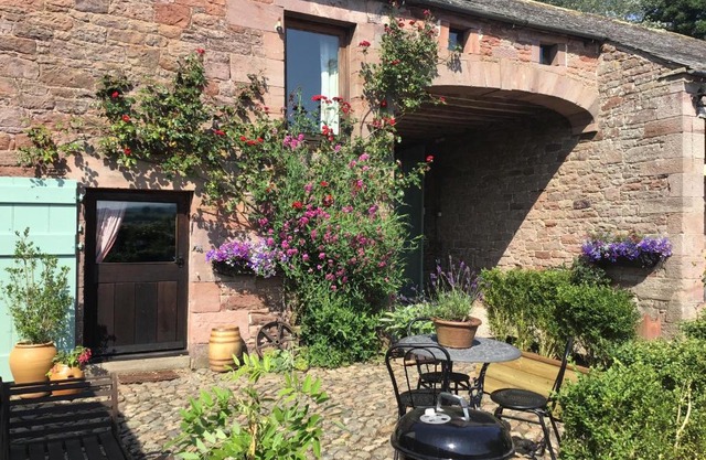 Historic converted byre in courtyard of 16C house