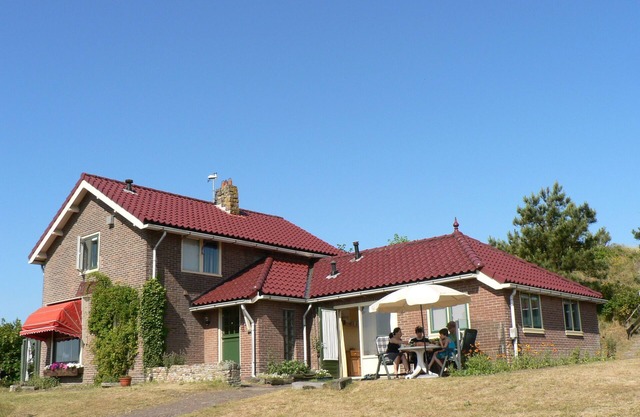 Holiday accommodation at the foot of the dunes of Petten beach.