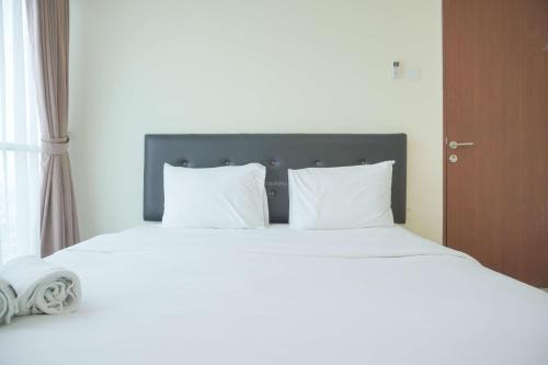 Homey and Comfortable 2BR Tifolia Apartment By Travelio