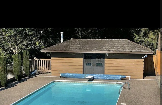 Italian theme villa with outdoor pool sitting on huge acreage lot.