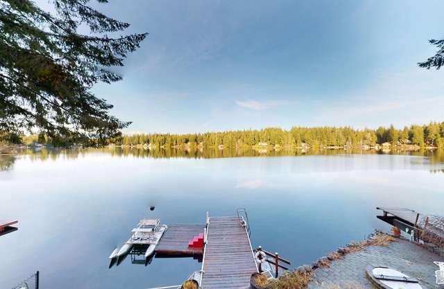 Lakefront studio-like home with beach access, lake views, wood stove, & firepit