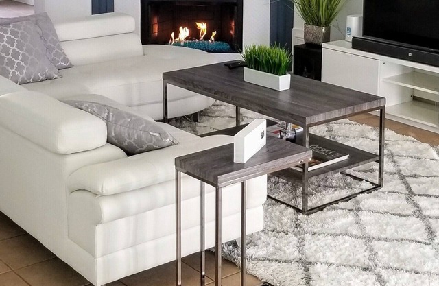 Modern 2br house with glass fireplace and patio.