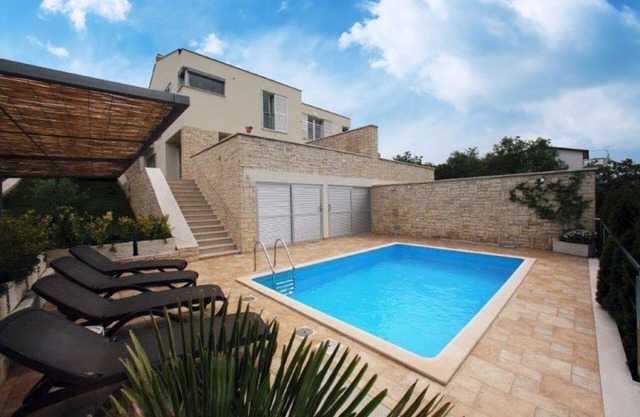 Modern holiday home with pool and fantastic views over nature to the sea