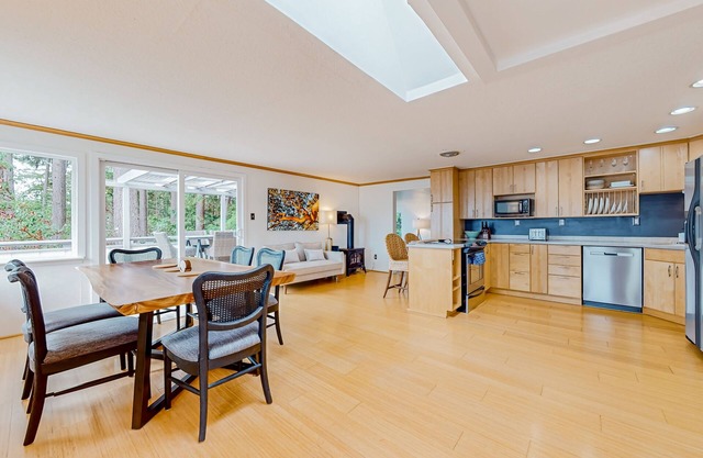 Modern water view retreat with foosball table, expansive deck, and gas fireplace