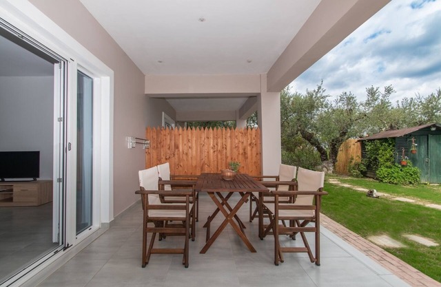 Nestled on the ground floor with direct garden access amidst olive trees