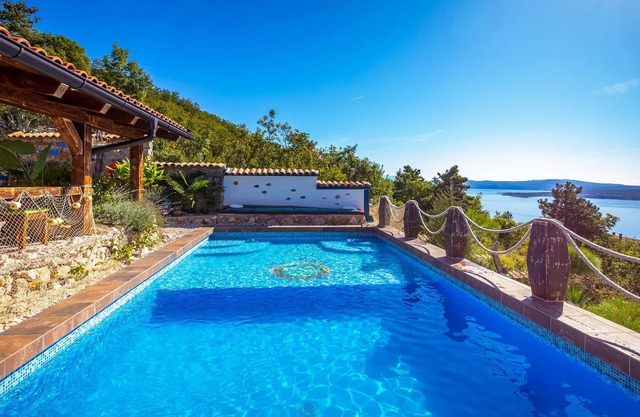 On a hill with a magnificent panoramic view of the sea and the islands is located this beautiful vac
