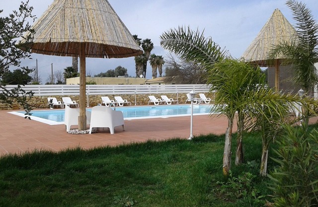 prestigious villa with swimming pool surrounded by greenery near the sea